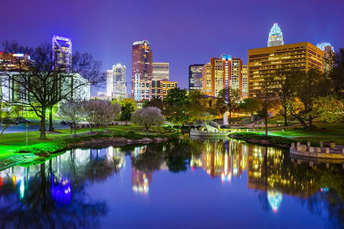 Charlotte, North Carolina skyline reflected in water at dusk