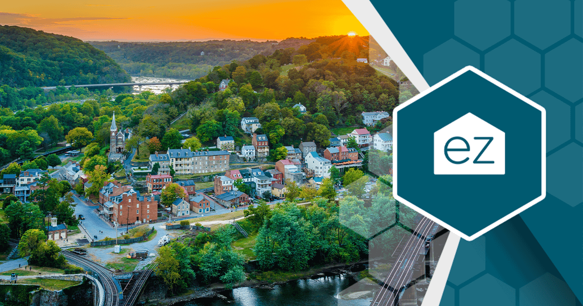 A small West Virginia town with a river and bridge surrounded by green hills