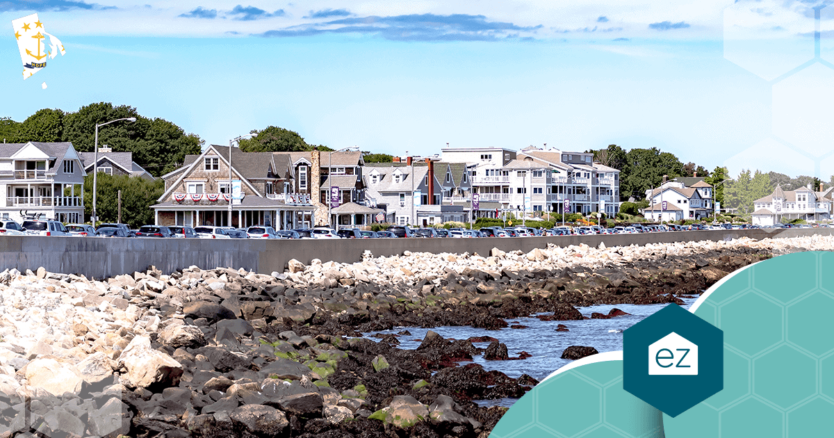 Rocky Narragansett, Rhode Island shoreline with multi-story houses and parked cars along the street