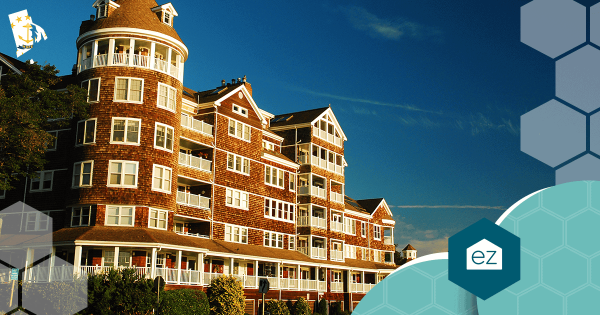 Large multi-story condominium building with shingles, white trim and balconies near Jamestown, Rhode Island