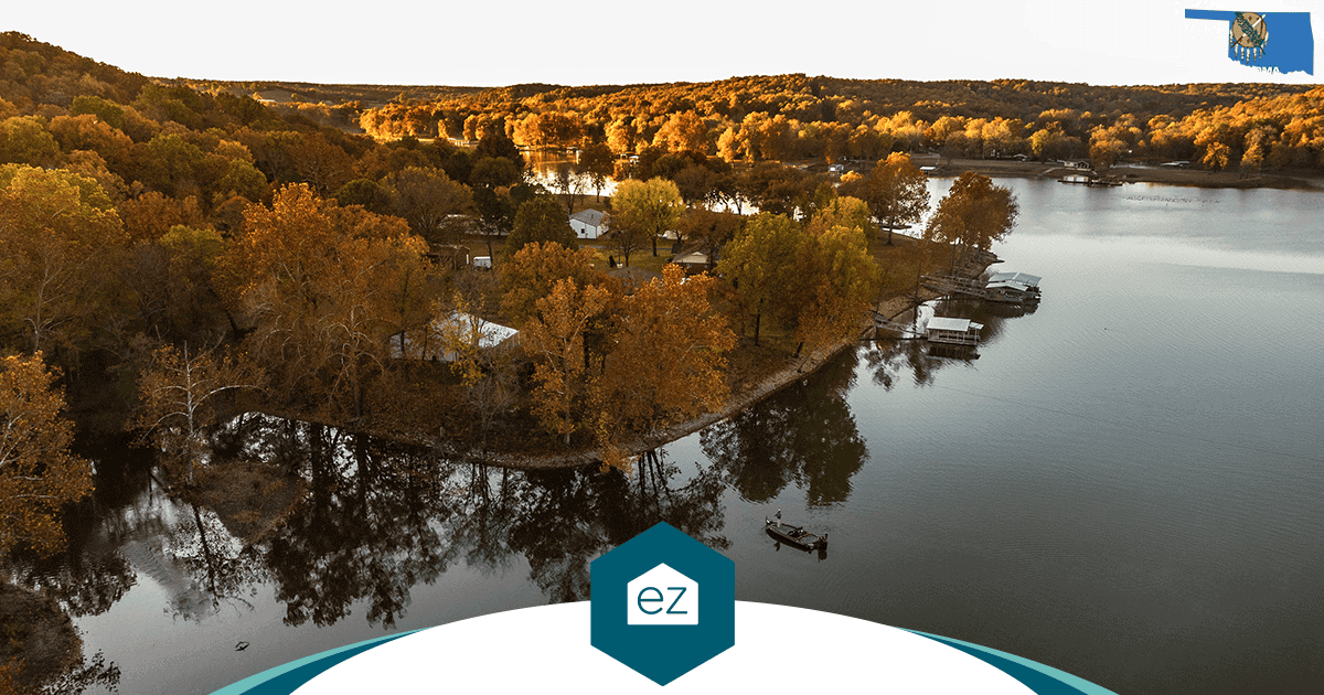 Aerial view of an Oklahoma lake with an autumn shoreline, docks and small lakeside houses