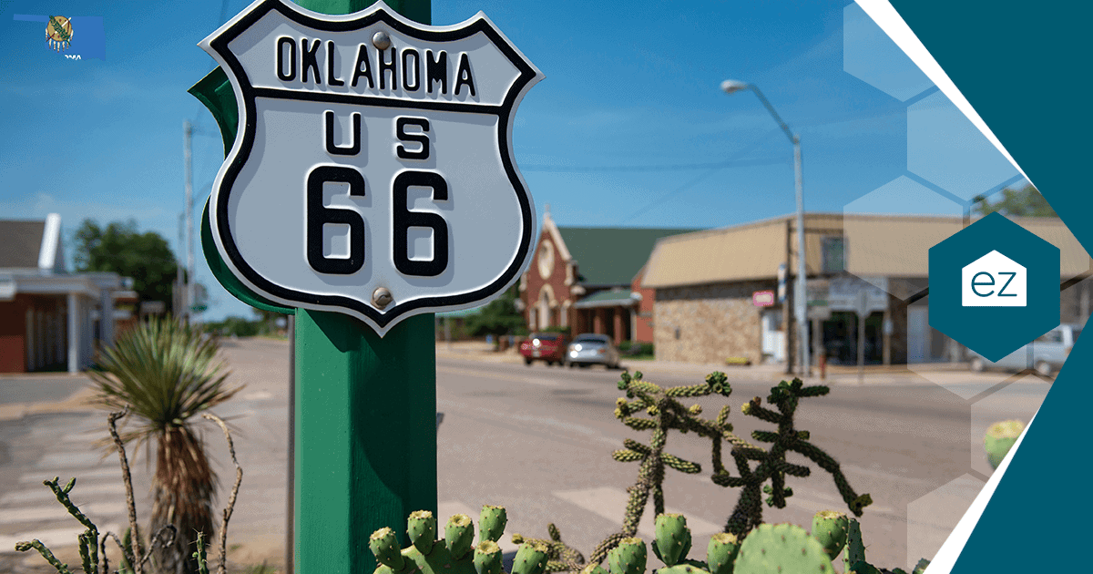 A US Route 66 highway sign marked Oklahoma mounted on a green pole