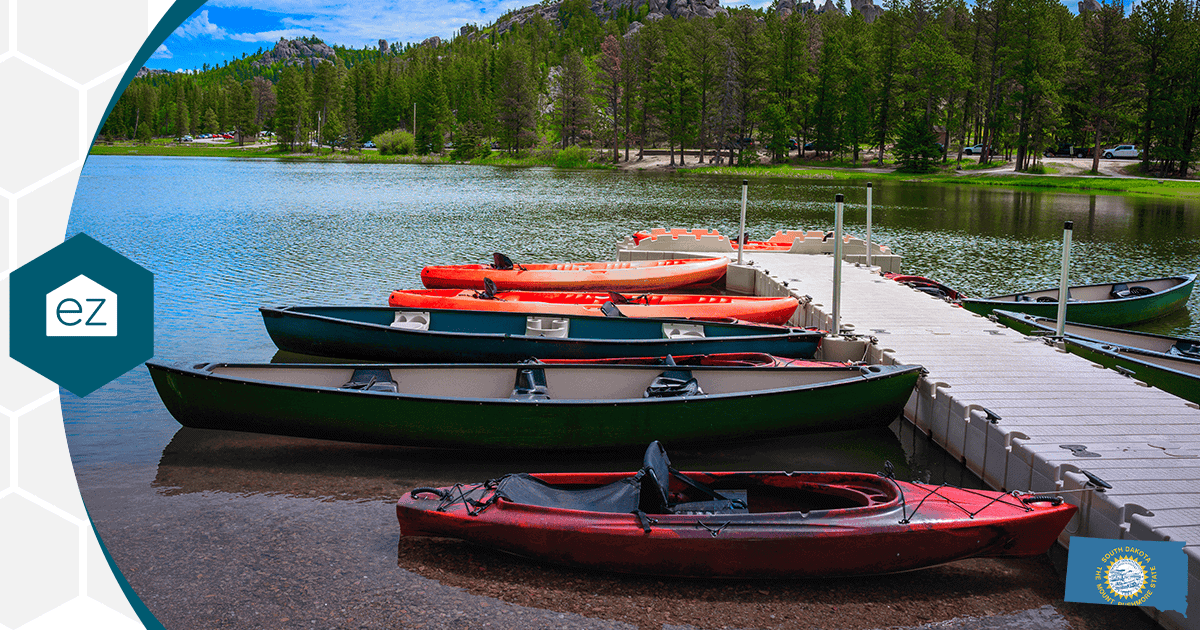 Kayaks and canoes lined along a floating dock on a calm South Dakota lake