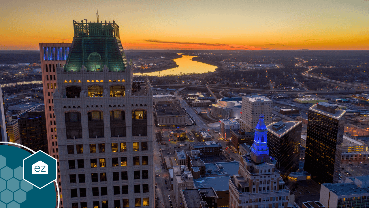 Downtown Tulsa at sunset with the Arkansas River behind it, the anchor market of Oklahoma's Green Country region