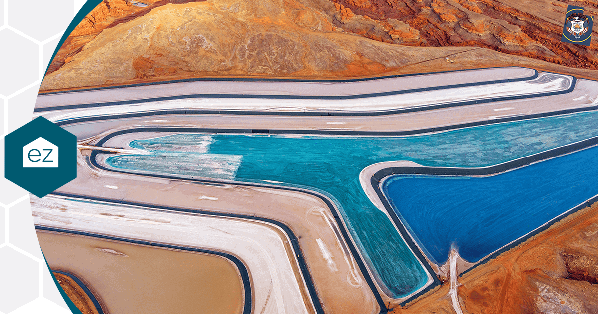 Aerial view of blue and turquoise Utah evaporation ponds against red terrain