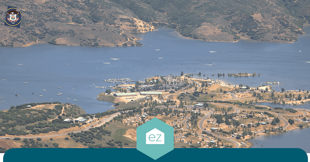 Aerial view of a small Utah lakeside community with waterfront homes and boat moorings