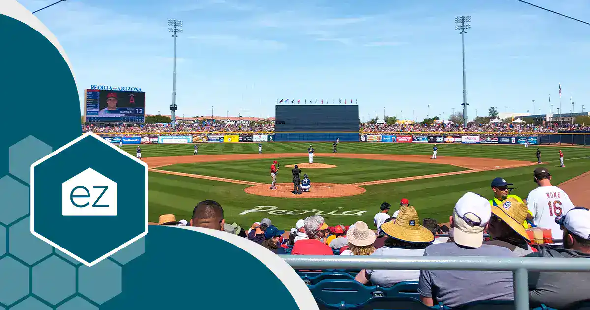 View of a baseball game in progress at a stadium, with players on the field, spectators in the stands, and a scoreboard in the background—perfect for Arizona real estate leads seeking vibrant community events on a sunny day.