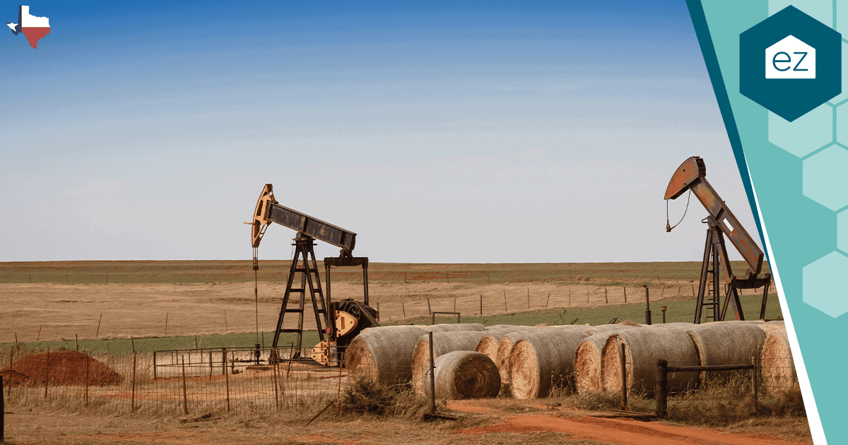 Two oil pumpjacks operating in a rural Texas field.