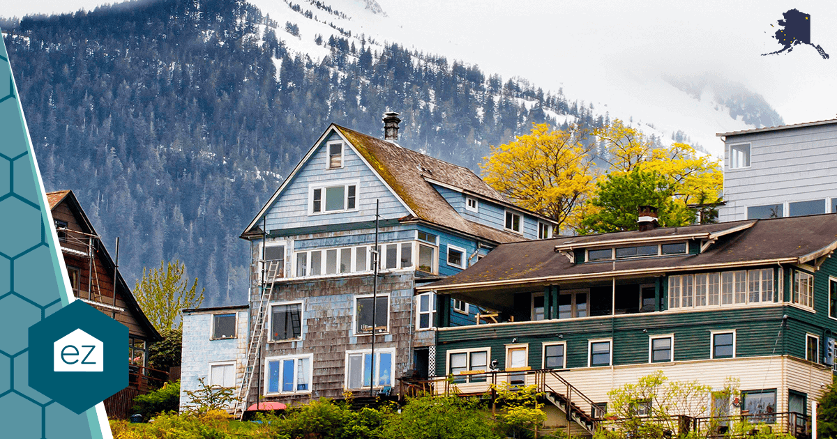 Hillside homes in Alaska backed by a snow-covered mountain, in a market where prices have climbed and inventory stays tight