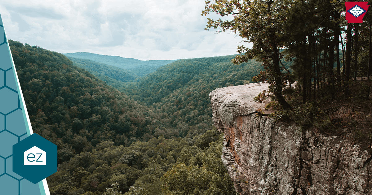 A rocky cliff overlooking forested hills in the Arkansas Ozarks.