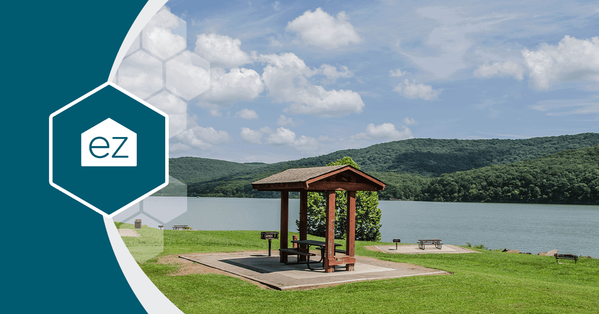 A picnic shelter beside a lake with forested hills near Fort Smith, Arkansas in the River Valley