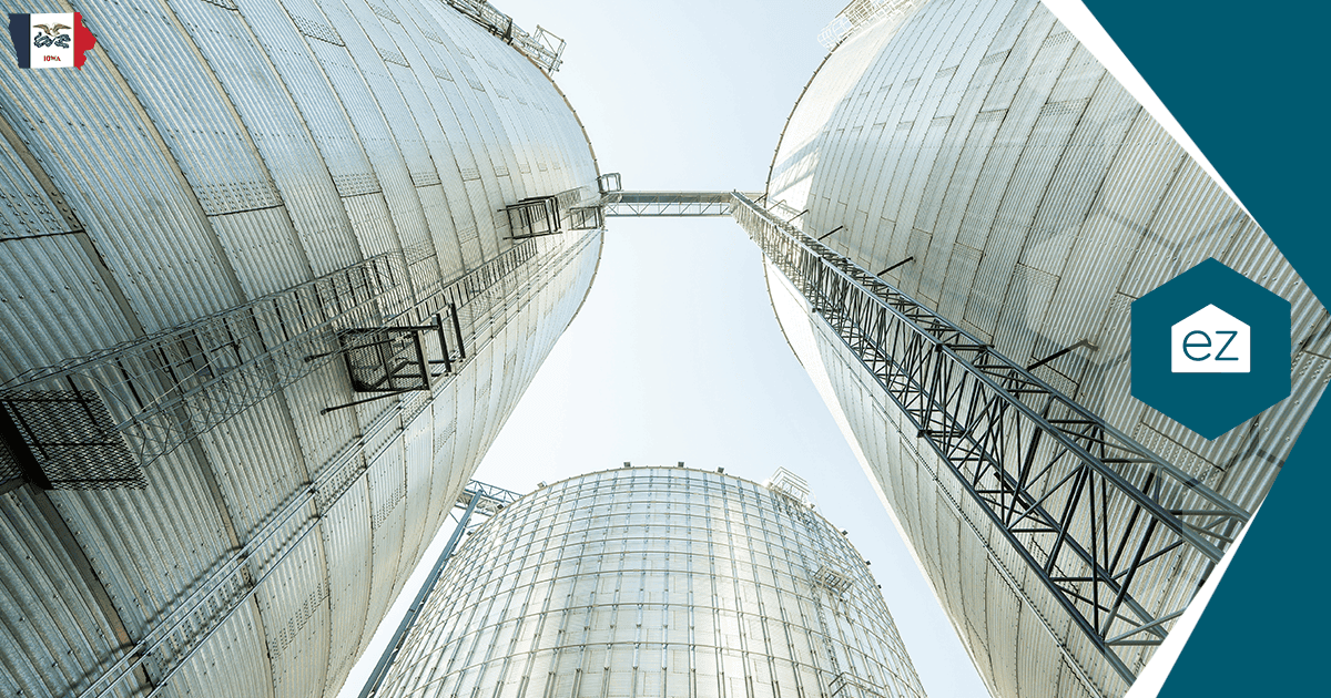 Grain storage silos against an open Iowa sky