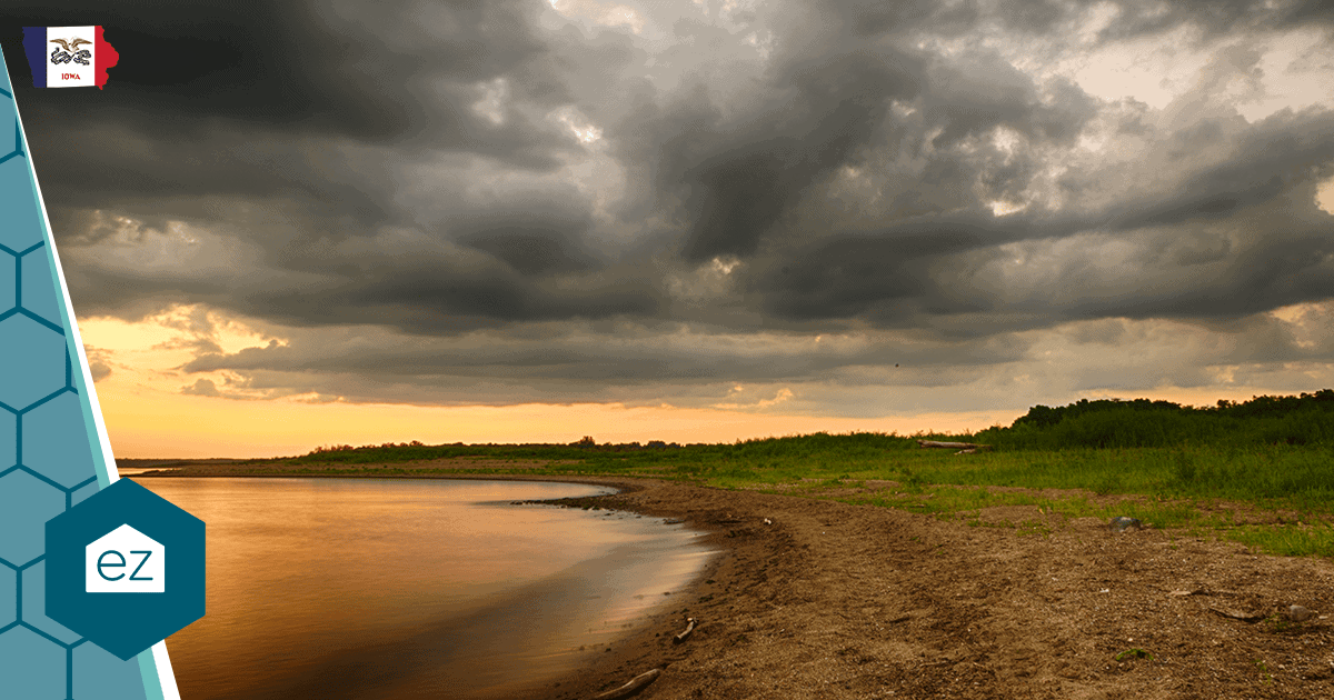 A quiet Iowa lake shoreline at sunset