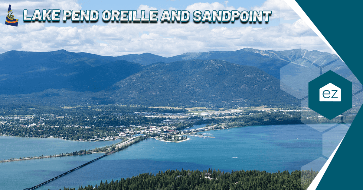 Aerial view of Lake Pend Oreille and the town of Sandpoint in North Idaho, with a bridge crossing the water and forested mountains beyond