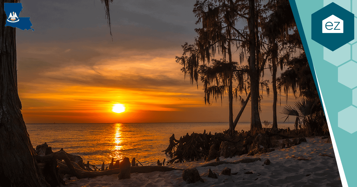 A Louisiana bayou at sunset with moss-draped cypress trees
