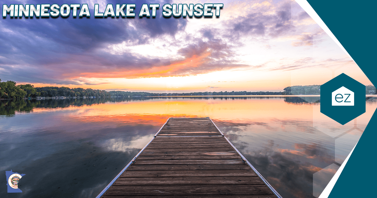 A wooden dock reaching over a calm Minnesota lake at sunset