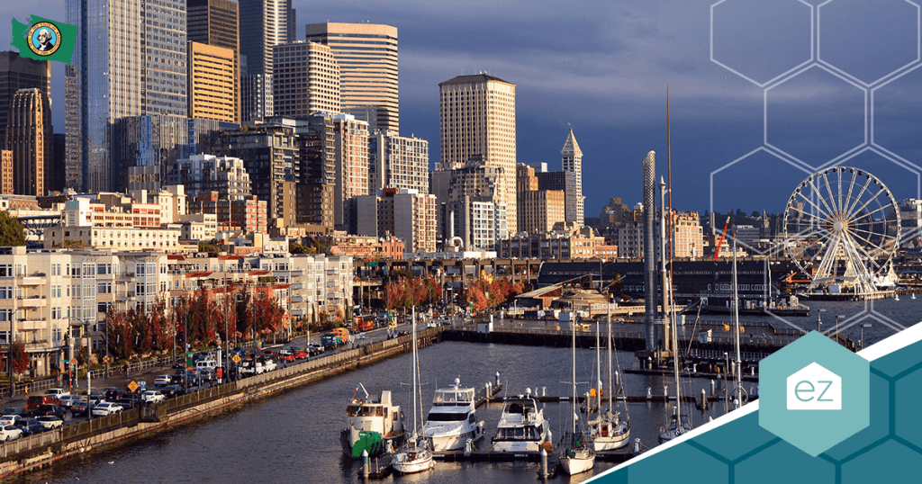 A city waterfront with boats docked at a marina, surrounded by high-rise buildings and a Ferris wheel under a partly cloudy sky.