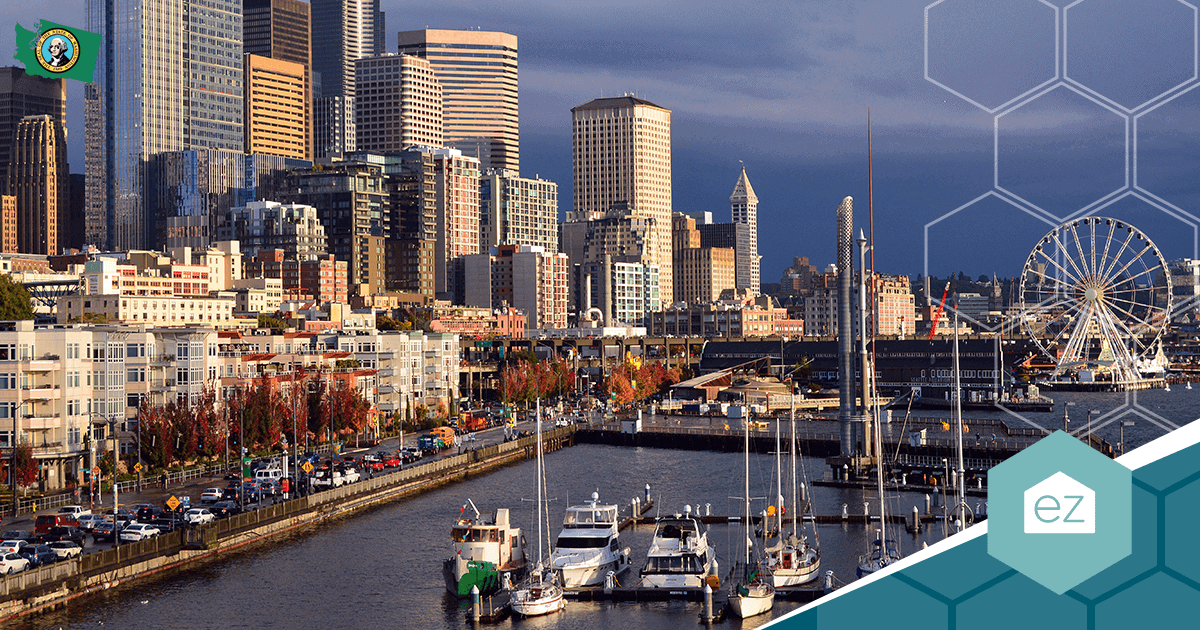 A city waterfront with boats docked at a marina, surrounded by high-rise buildings and a Ferris wheel under a partly cloudy sky.