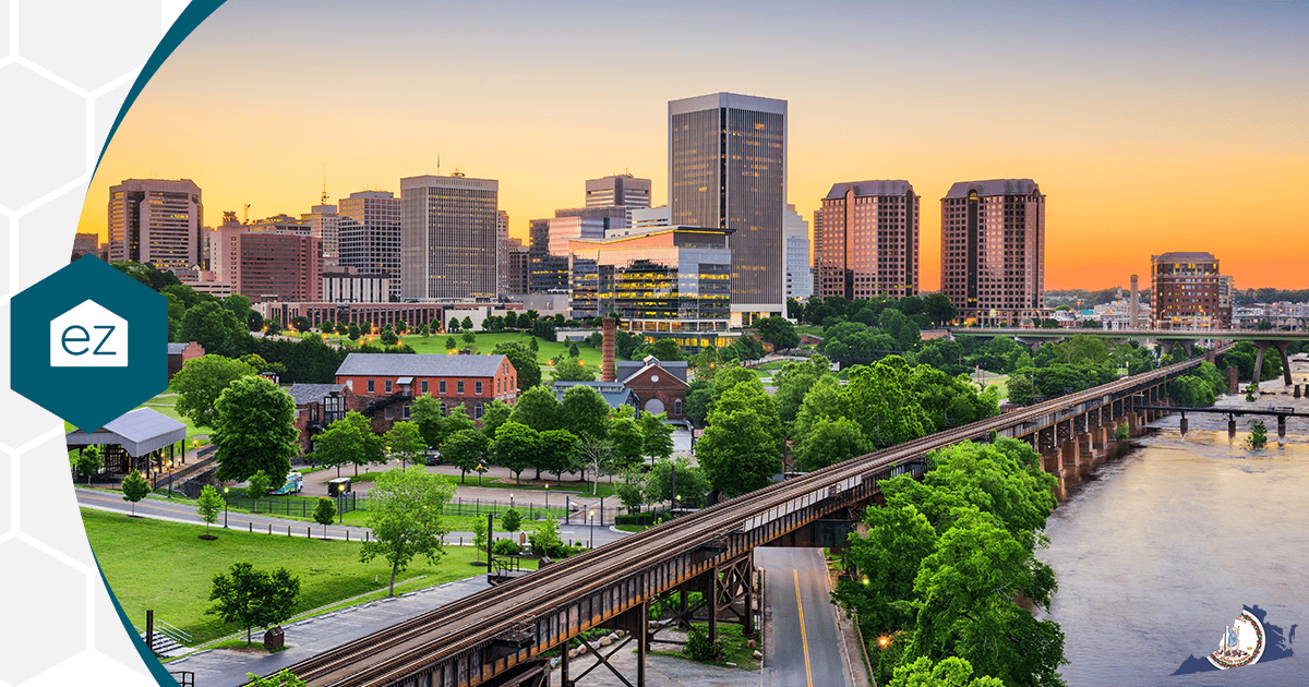A Northern Virginia city skyline at sunset with modern and historic buildings beside a river