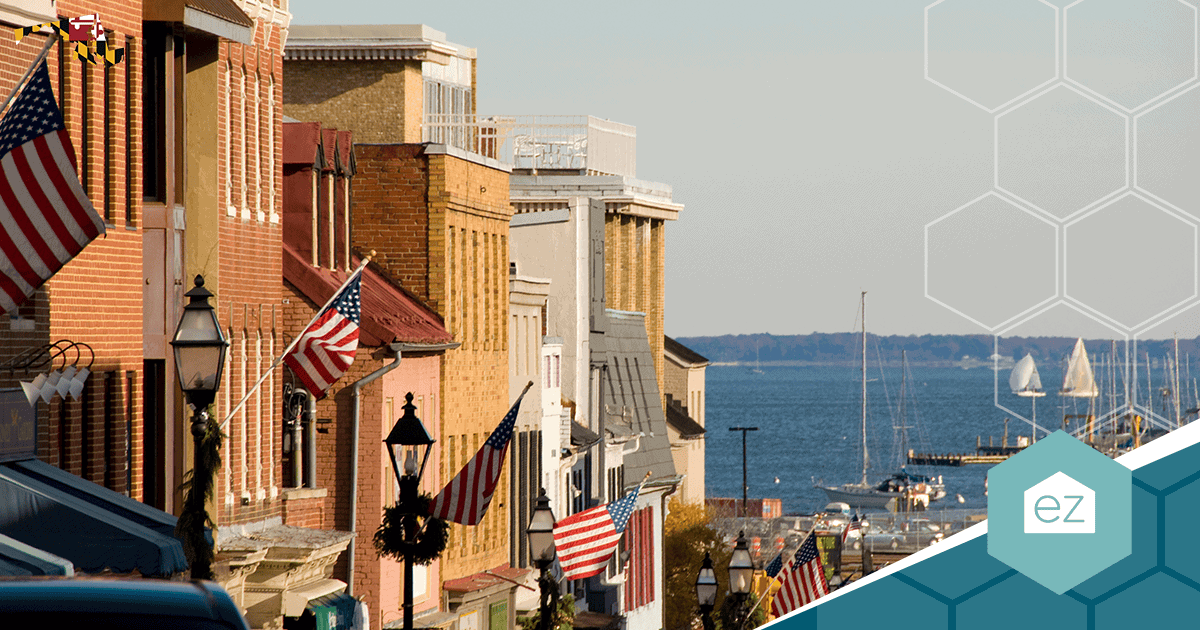 Historic Annapolis waterfront with brick buildings, American flags, and sailboats in Maryland