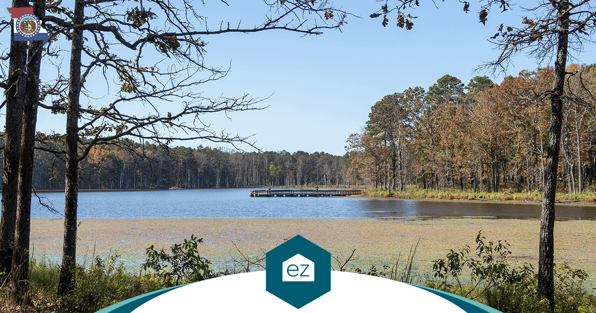 Calm Missouri lake with a wooden dock and wooded shoreline