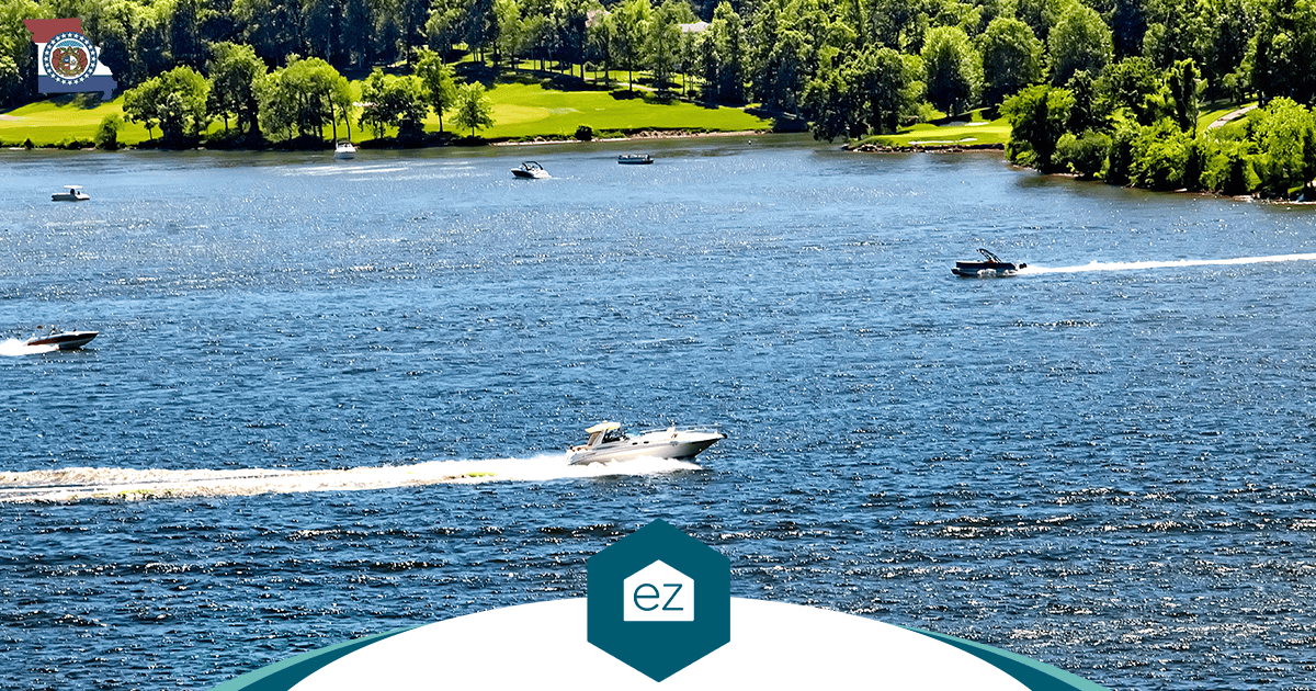 Boats on a Missouri lake bordered by green trees