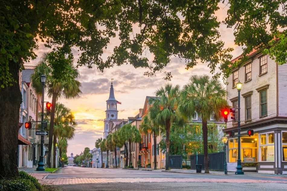 Historic street with palm trees and a church steeple in Charleston, South Carolina
