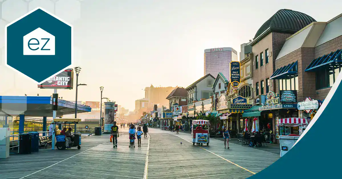 The Atlantic City boardwalk lined with shops beneath high-rise buildings on the New Jersey shore