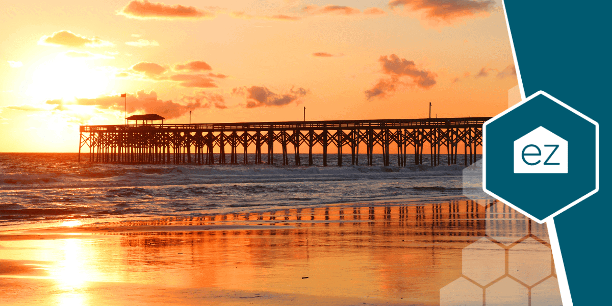 Wooden pier stretching into the ocean at sunset in Myrtle Beach, South Carolina