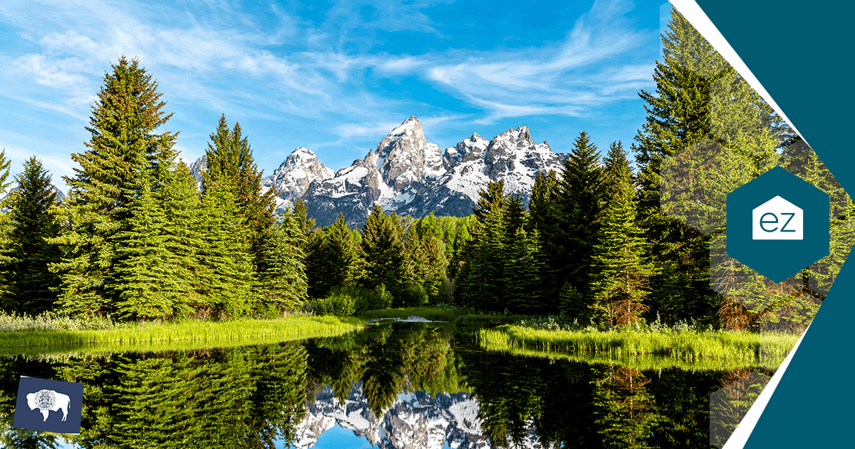 The Grand Teton range reflected in a still Wyoming lake in Teton County, where average rents run roughly three times the statewide average