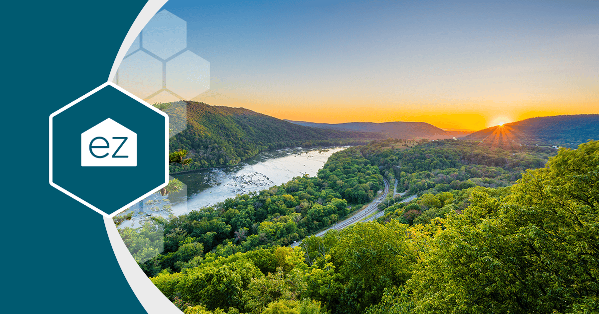 A river winding through a forested West Virginia valley at sunset
