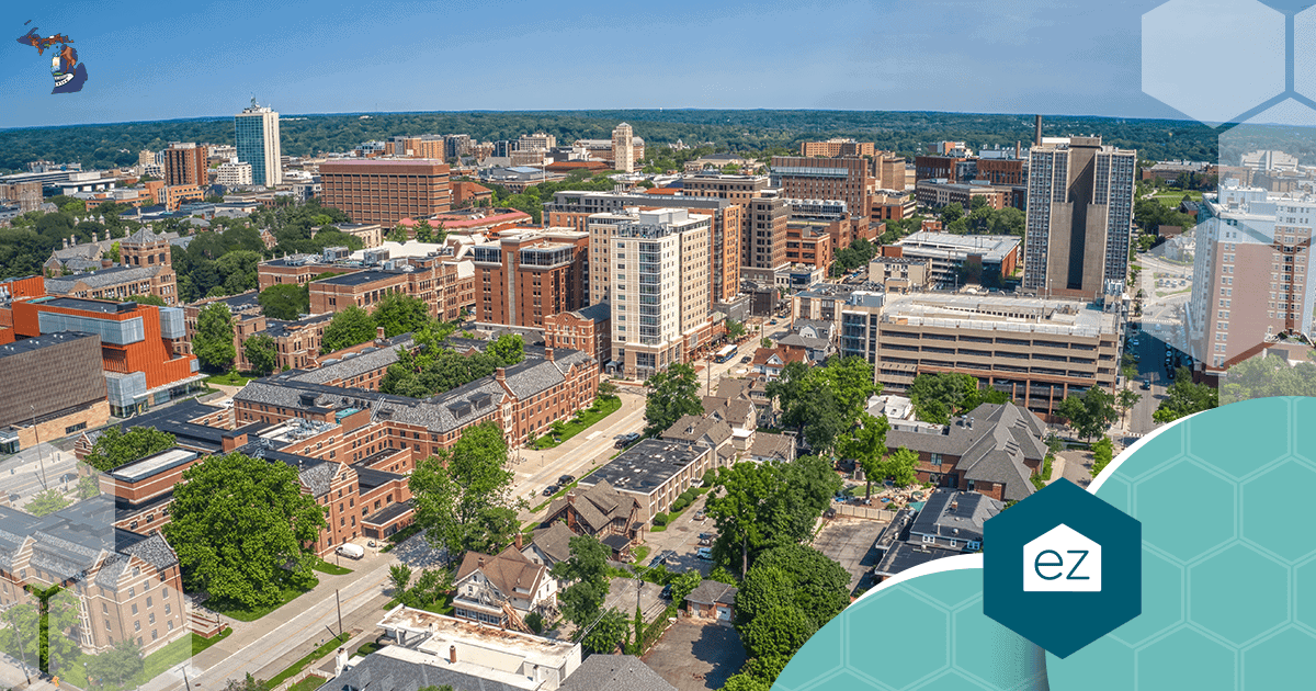Aerial view of the Ann Arbor, Michigan cityscape with tree-lined streets and mid-rise buildings