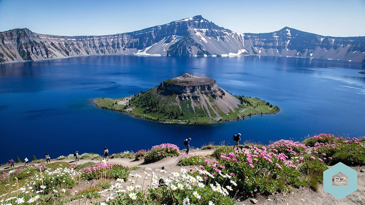 Crater Lake in southern Oregon, its deep blue water ringed by the caldera rim in summer