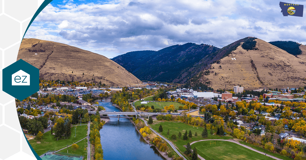 Aerial view of Missoula, Montana, with the Clark Fork River winding between tree-covered hills