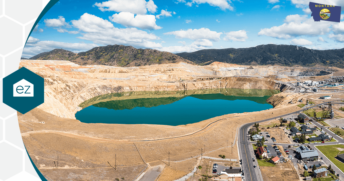 A large open-pit mine and lake near a Montana town, part of the state's resource economy