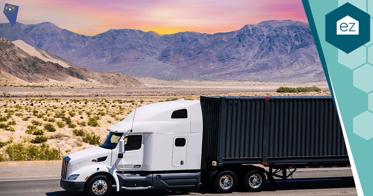 A semi-truck on a desert highway between Nevada mountains