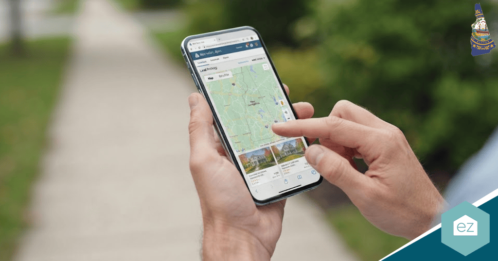 A person uses a smartphone to view a map with location markers while walking on a sidewalk outdoors, possibly searching for New Hampshire real estate leads.