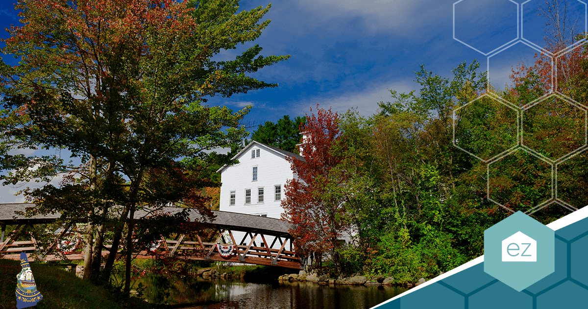 New Hampshire covered bridge over a river with autumn foliage