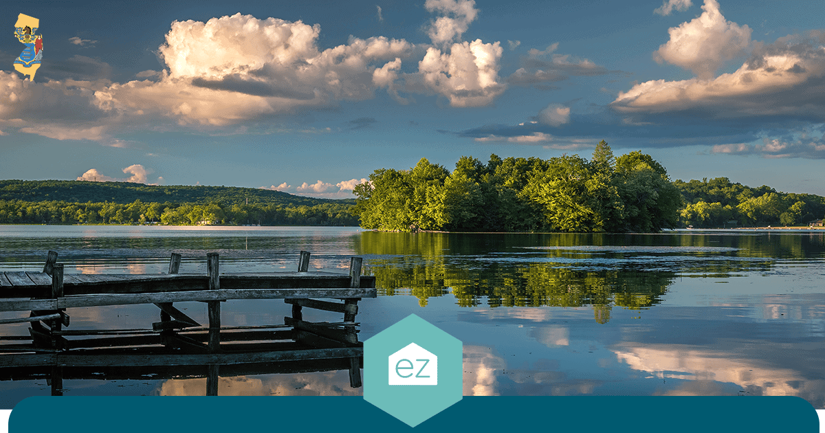 A wooden dock reaching into a calm lake in northwestern New Jersey