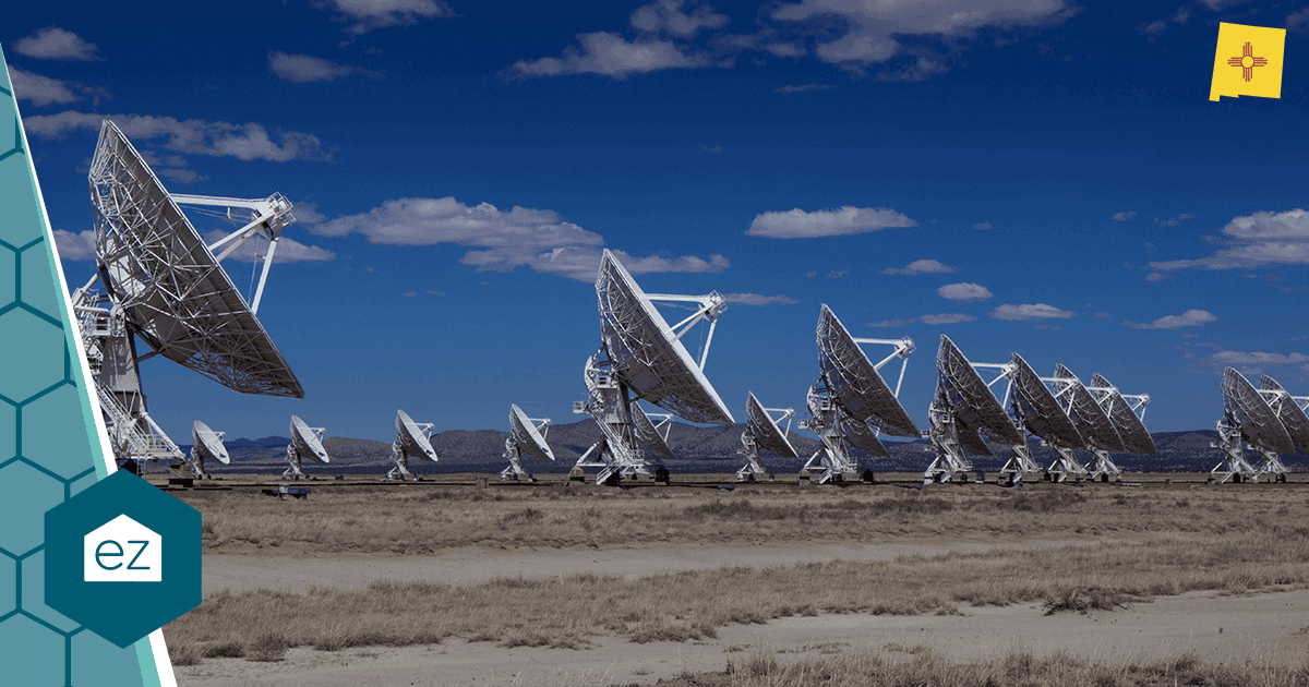 Row of large radio telescopes at the Very Large Array in the New Mexico high desert