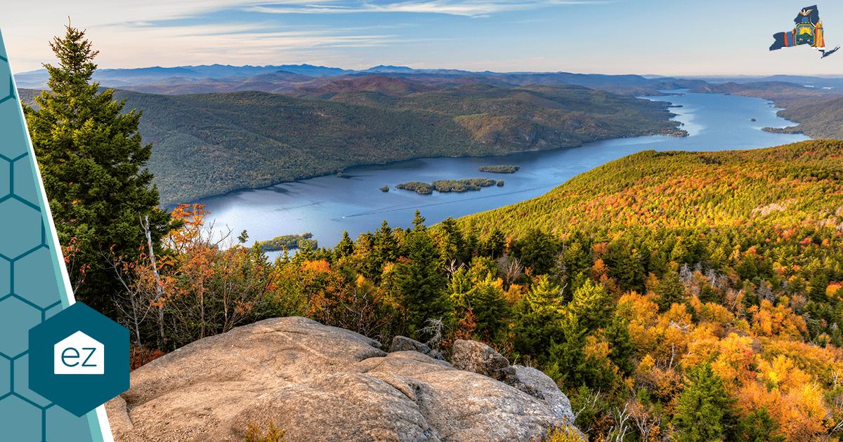 Rocky overlook above an Adirondack lake in New York surrounded by forested hills in fall color