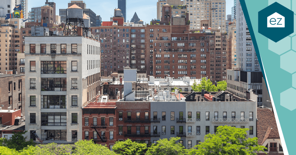 Cityscape view of mid-rise residential and commercial buildings, home to real estate owners and bustling businesses, with rooftops and green trees in the foreground under a clear sky—an ideal setting for generating New York Real Estate Leads and connecting with exclusive pre-market leads.