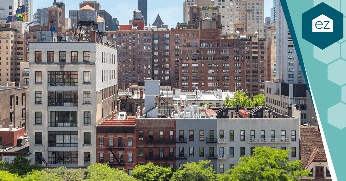 Cityscape view of mid-rise residential and commercial buildings, home to real estate owners and bustling businesses, with rooftops and green trees in the foreground under a clear sky—an ideal setting for generating New York Real Estate Leads and connecting with exclusive pre-market leads.