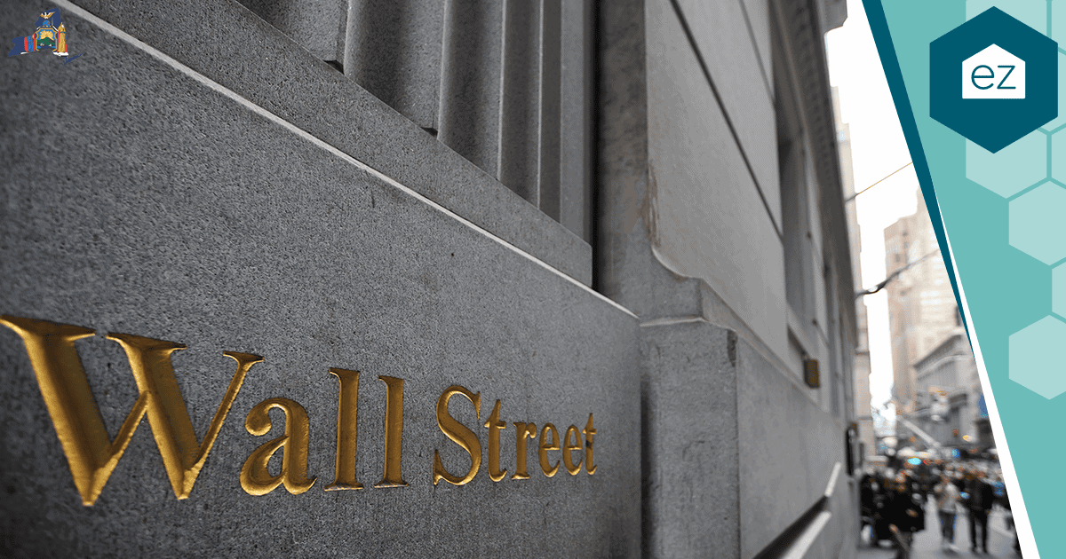 The Wall Street sign in gold lettering in New York City's Financial District