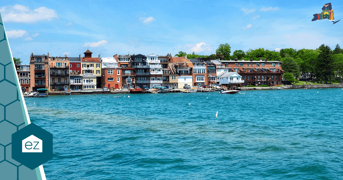 Colorful waterfront buildings in a small New York river town with boats docked along the shore