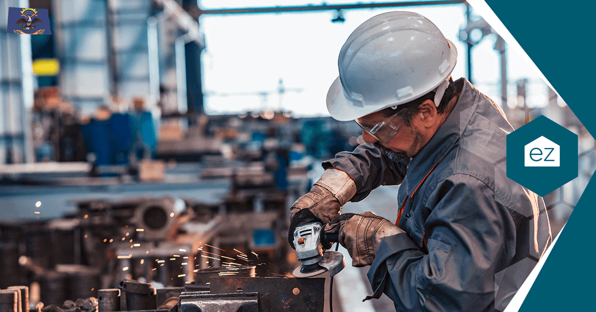 A North Dakota worker using a grinding tool in an industrial workshop