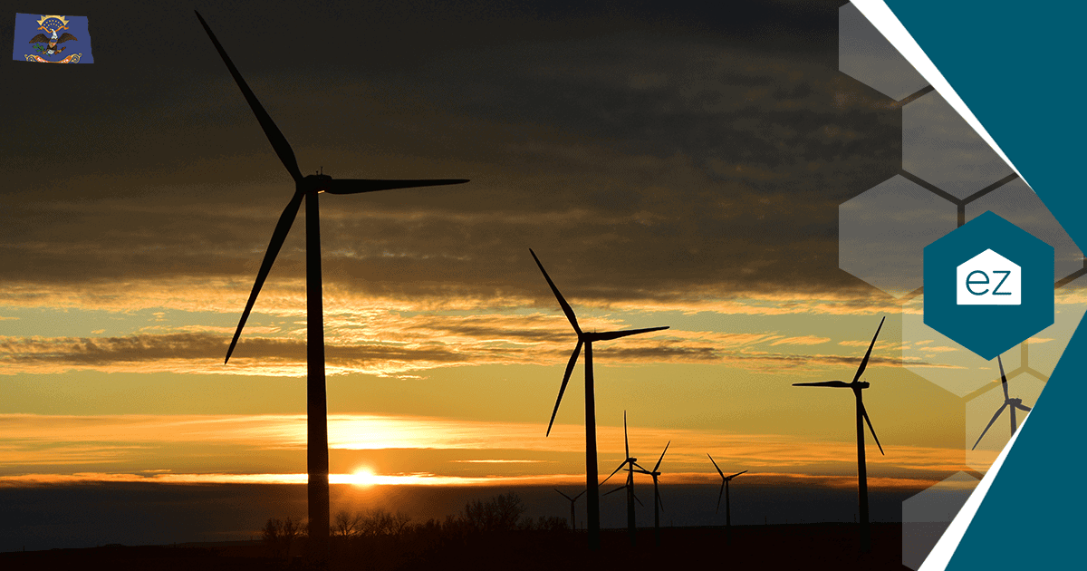 A row of wind turbines against a North Dakota sunset sky