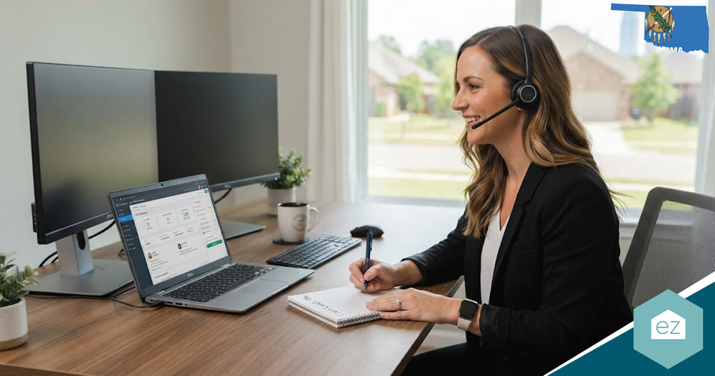 Woman wearing a headset sits at a desk with a laptop and two monitors, jotting down Oklahoma real estate leads during a video call in a bright home office.