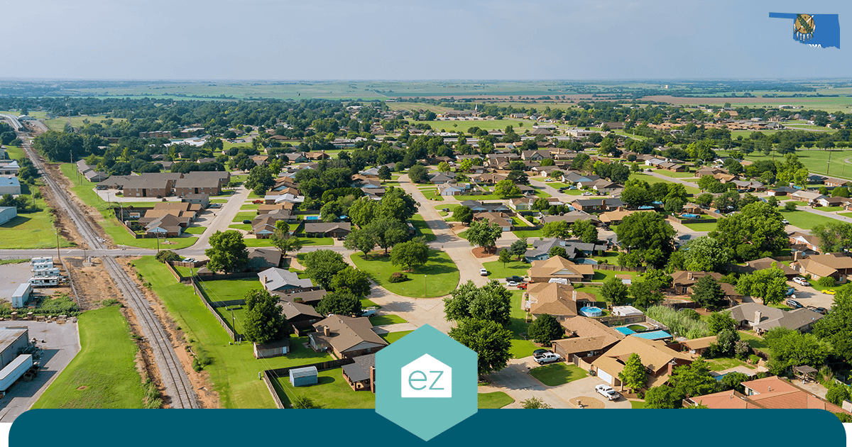 Aerial view of an Oklahoma suburban neighborhood of single-family homes with green lawns and mature trees