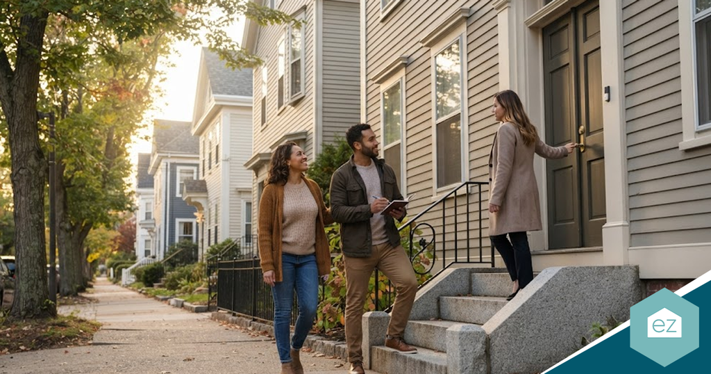 A real estate agent discussing Rhode Island real estate leads with a couple standing on the front steps of a house.